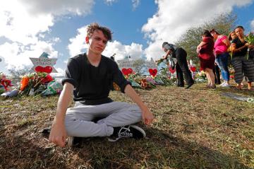 Student at a memorial outside Marjorie Stoneman Douglas High School (AP Photo/Gerald Herbert