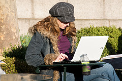 Woman using a laptop outside image link to story