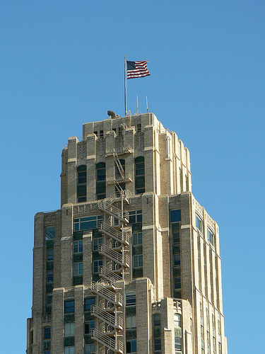 skyscraper with American flag on top image link to story