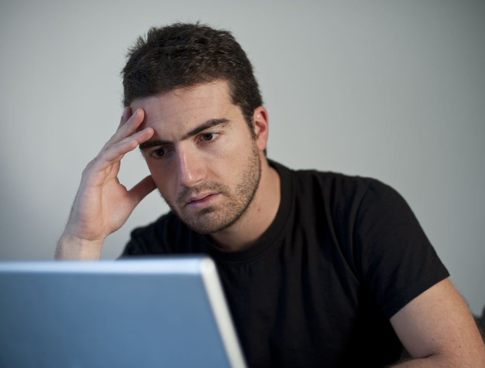 Man looking frustrated at the computer image link to story