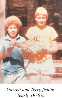 two young boys holding a fish