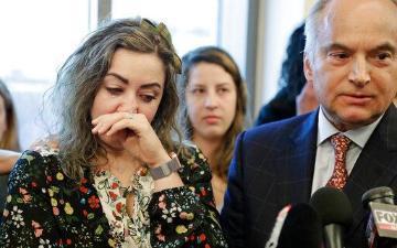 RaDonda Vaught, left, wipes away tears as her attorney, Peter Strianse, right, talks with reporters after a court hearing Wednesday, Feb. 20, 2019, in Nashville, Tenn.