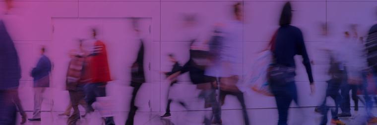blurred abstract image of people walking in a building hallway