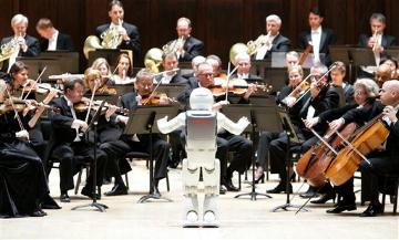 Honda's ASIMO robot conducts the Detroit Symphony Orchestra as it performs 