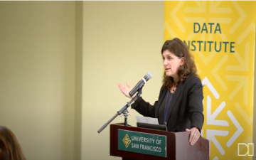 Irina Raicu speaks at podium at CADE Conference in November, 2019