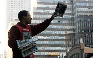 Man passing out newspapers