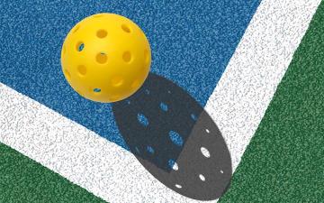 Pickleball laying on a blue court image link to story