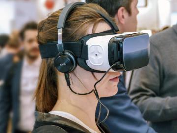 A woman wears a Virtual Reality headset. image link to story