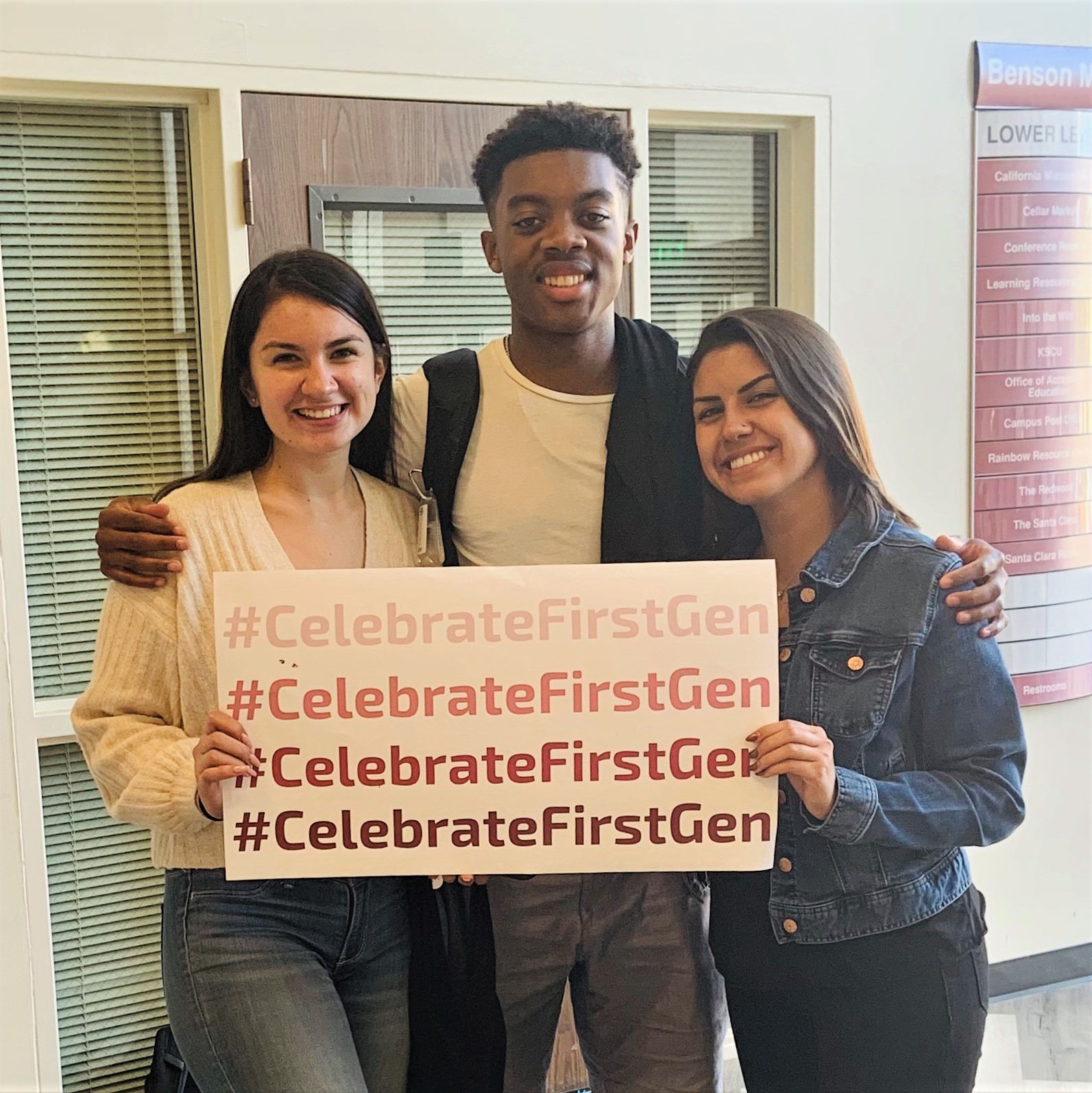 Three students pose with a #CelebrateFirstGen sign 