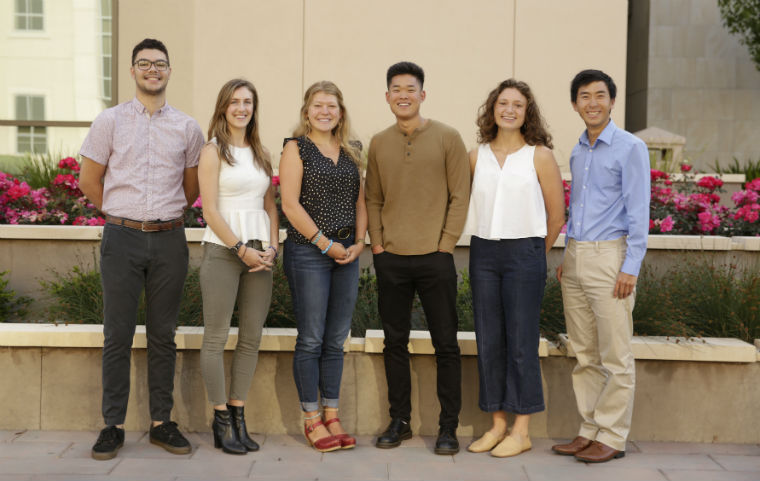 Six student Fulbright and Coro award winners posting near Charney Hall  image link to story