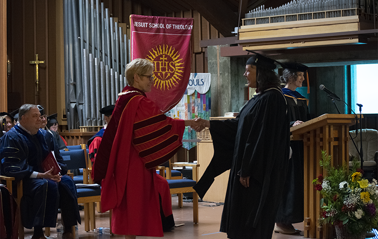President Sullivan shaking hands with a JST graduate at Commencement 2023 image link to story