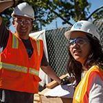 Two students with high visibility vests and hard hats. Links to Civil, Environmental, and Sustainable Engineering BS page.