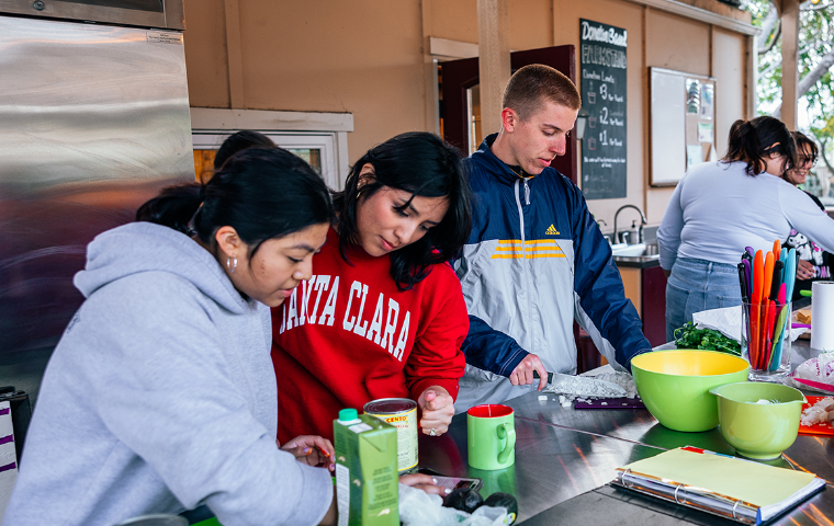 Students preparing a Nourish Nights Meal in the Forge Garden Outdoor Kitchen.
