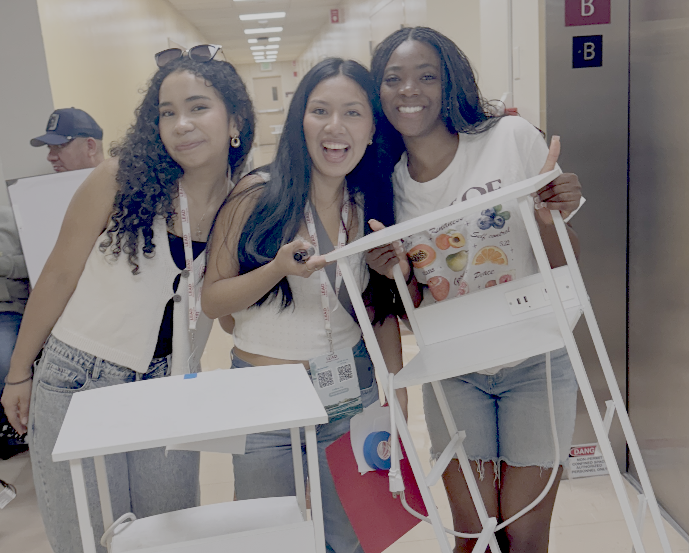 3 students show off the organizers they found at Bronco Surplus