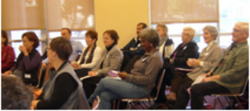 People sitting in a room, likely at a membership registration event.