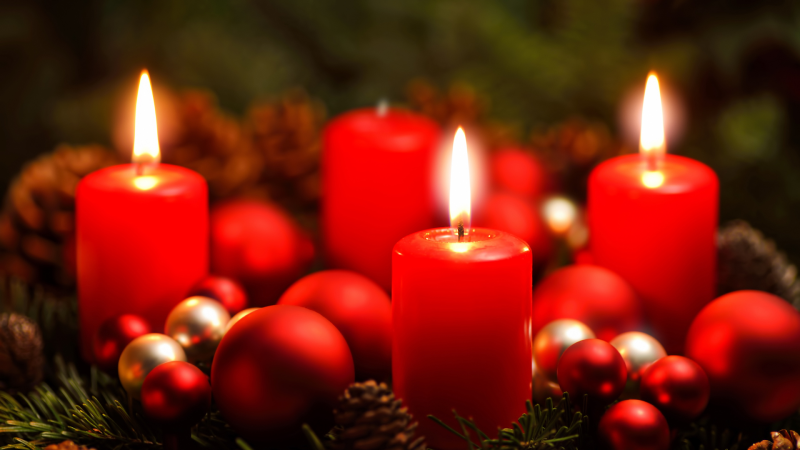 Red candles surrounded by ornaments