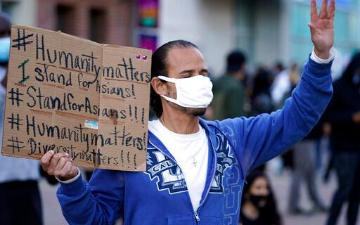 An Asian man demonstrates at a anti-Asian violence protest