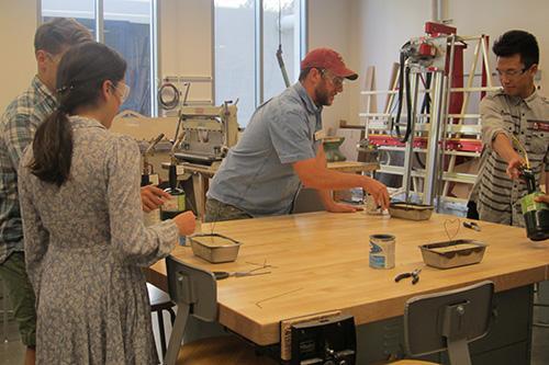 People working on art projects in a studio.