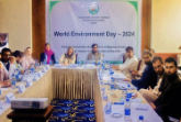 World Environmental Day Conference in Kabul, presenters meeting around conference tables 
