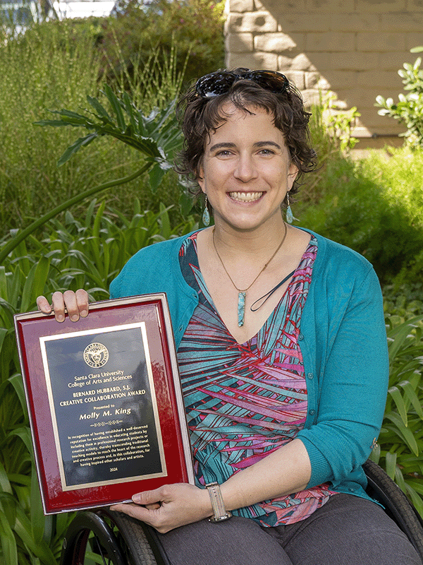 Molly King holding her award