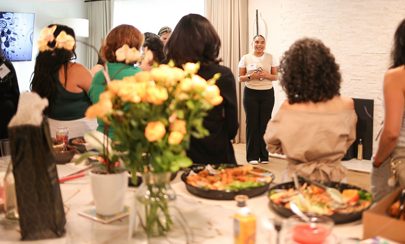 A smiling Danae Rivera leads a group of women