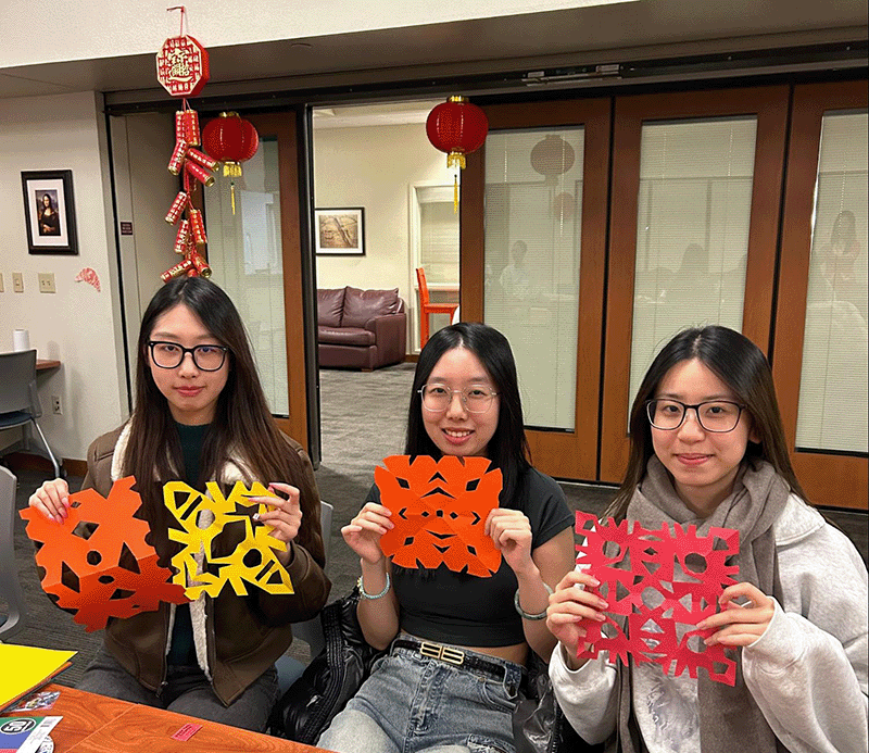 Students with their cut art work during the 2024 Lunar New Year celebration