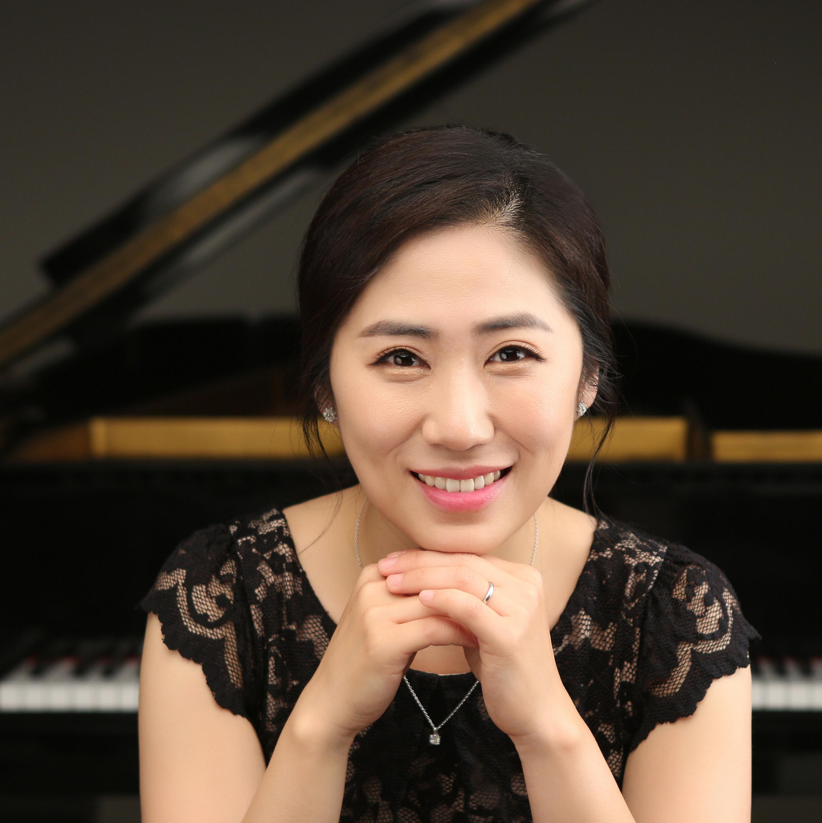 Sun Ha Yoon with a piano behind her