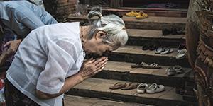 Woman bowing outside holy place
