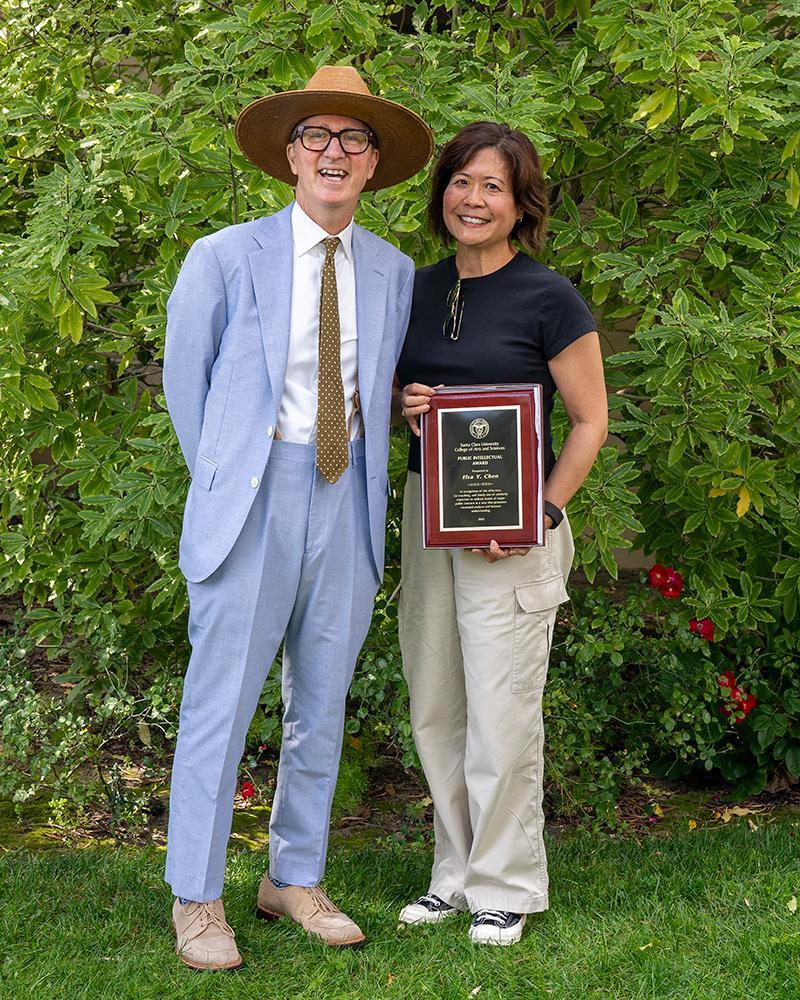 Dean Daniel Press with Elsa Chen holding her award in the SCU Mission Garden