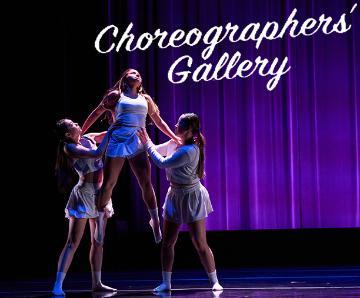 Female dancer in white being lifted straight up by 2 other female dancers in white with a purple background