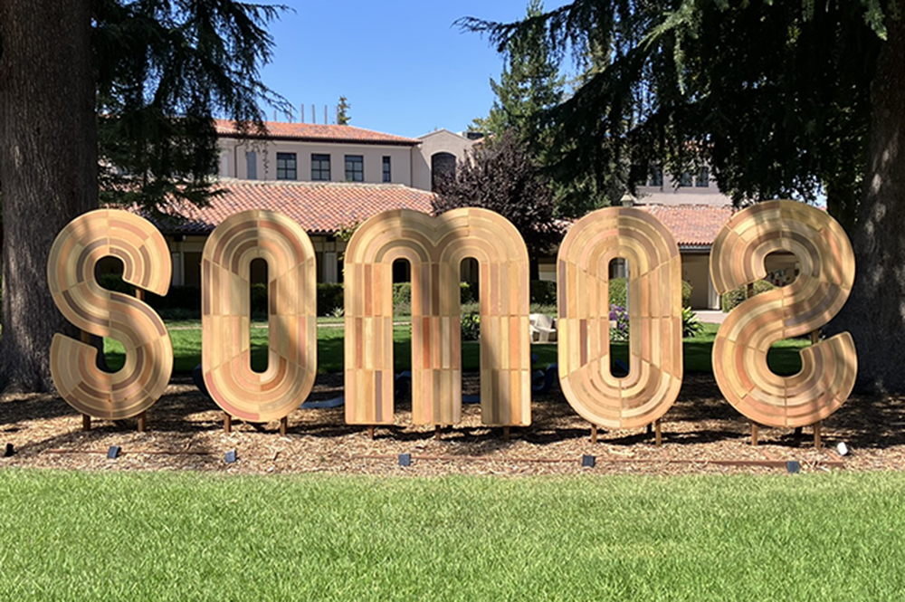 sculpture of letters creating the word SOMOS installed outdoors