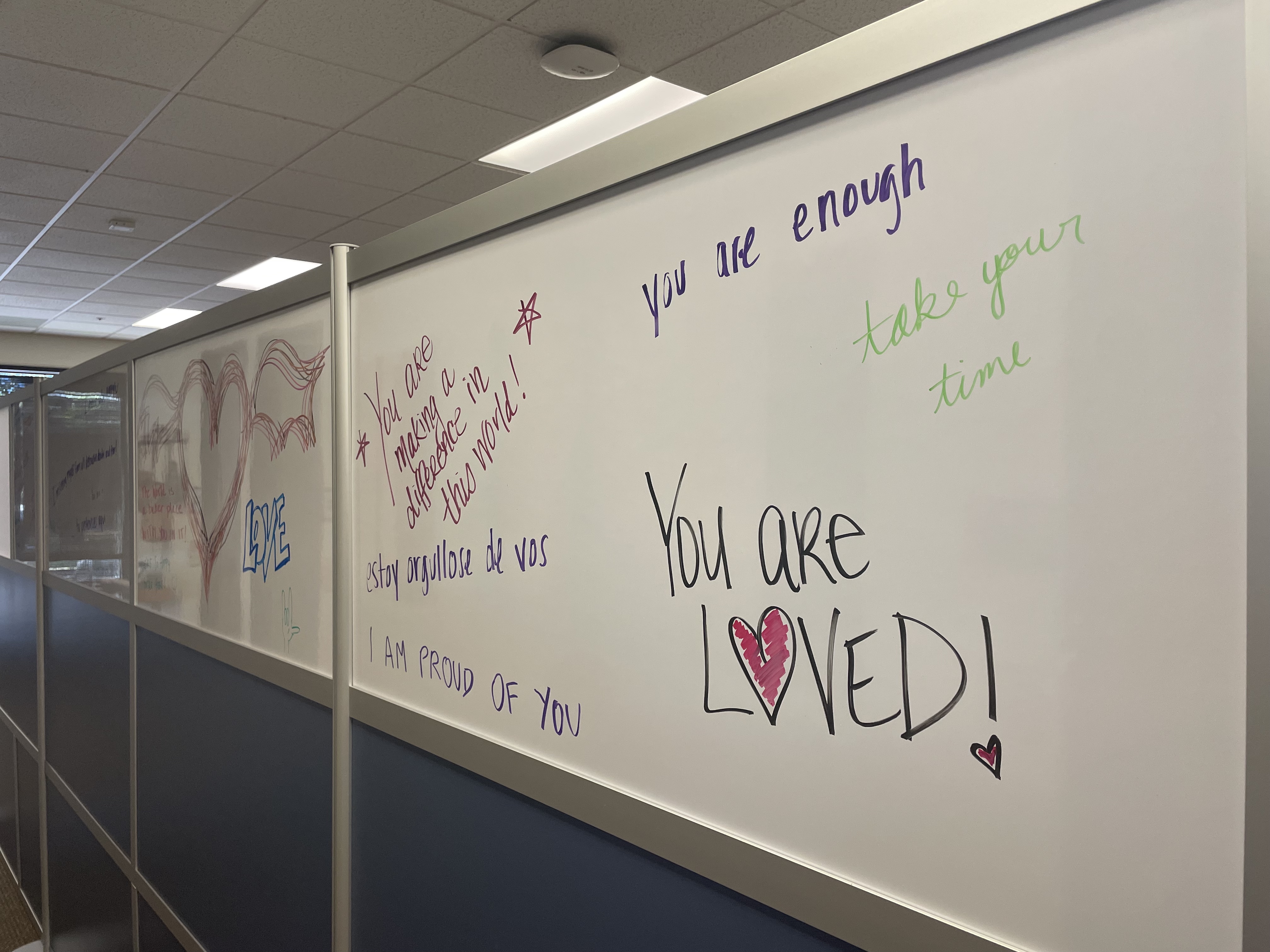 Outside of therapy rooms, the Gender Affirming Care Clinic team writes positive messages for clients to see as they exit their sessions.