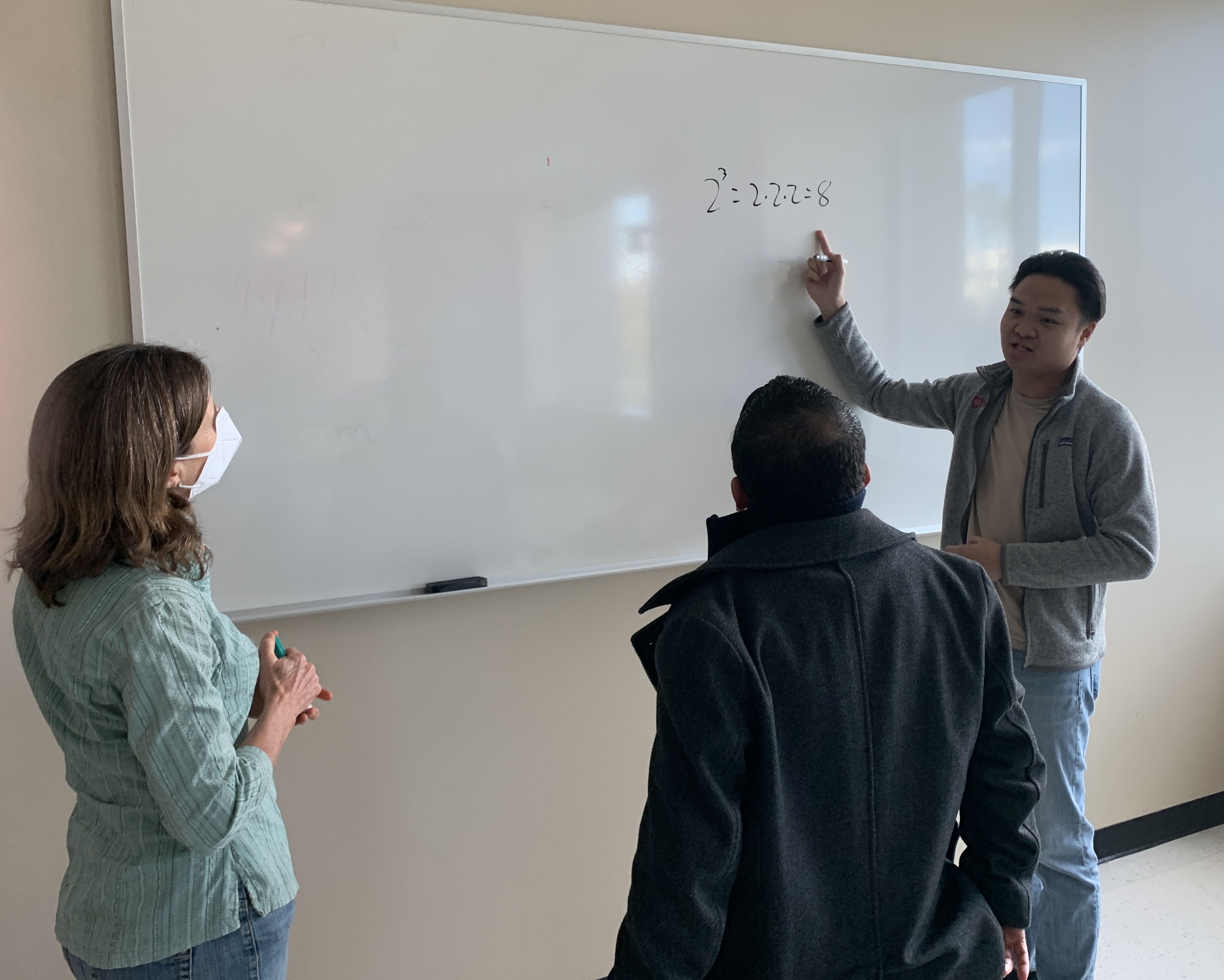 Noyce Fellows Miguel Garcia and Daniel Pham in collaboration with Mathematics Professor Linda Burks at a Noyce Fellowship Workshop.