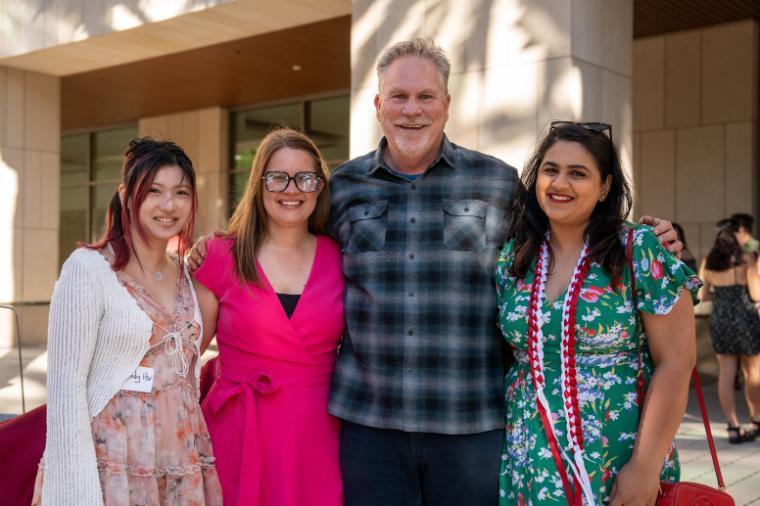 4 people posing at the camera at Education Graduation Reception