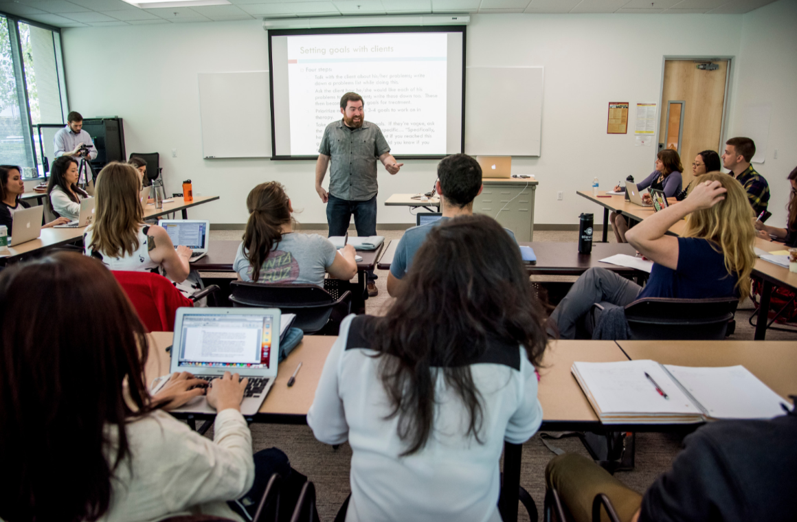 A professor speaking in a classroom 