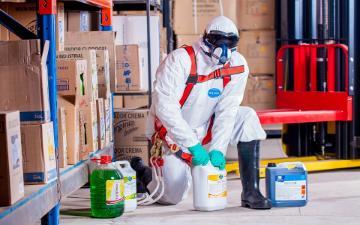 worker in hazmat suit working with chemicals