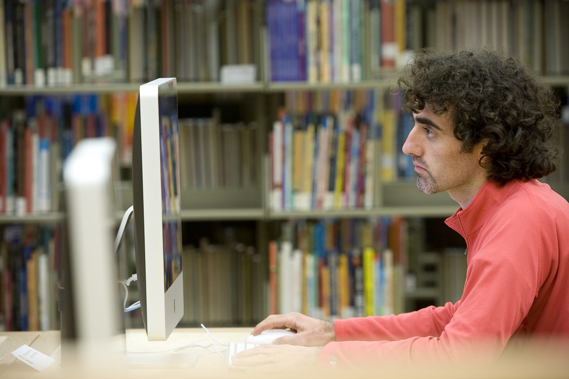 SCU student does research at the campus learning commons.