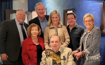 SCU President Julie Sullivan presents the Marty Melone Family with Founders Society Award in December, 2024. Pictured in photo: (seated) Marty Melone ’63; (standing l. to r.) Markkula Center for Applied Ethics Executive Director Don Heider, Donna Melone, Ethics Center Senior Director of Development Jim Kambe ’84, Markkula Center Advisory Board Member Denise Melone ’06, David Melone ’95, and Santa