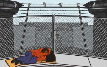 A drawing depicting an unhoused person sleeping on the sidewalk near the chain linked and barbed wire fence of a prison, flanked on each side by two guard towers. 