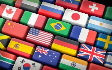 A computer keyboard with each key displaying the flag from a different country. Image by Gino Crescoli from Pixabay.