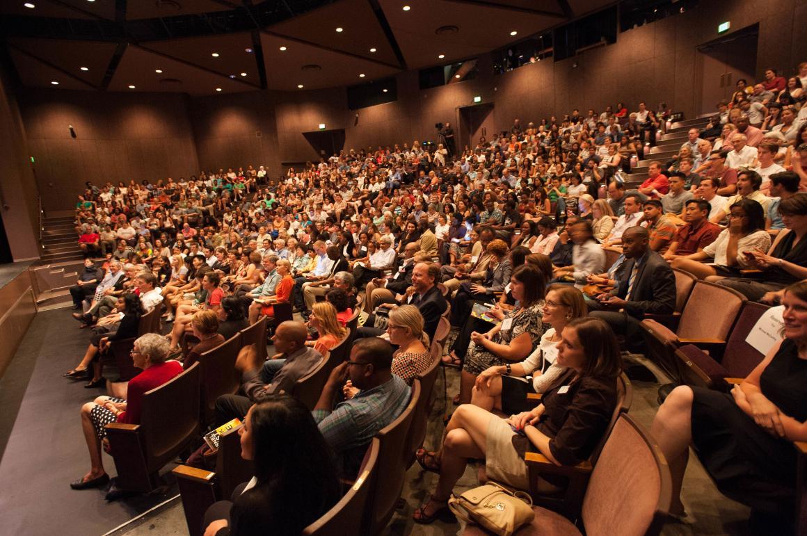 A crowded auditorium filled with seated people.