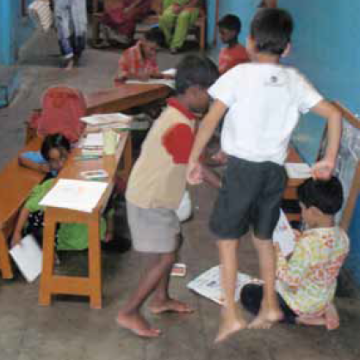 Children interacting and doing activities in a classroom.