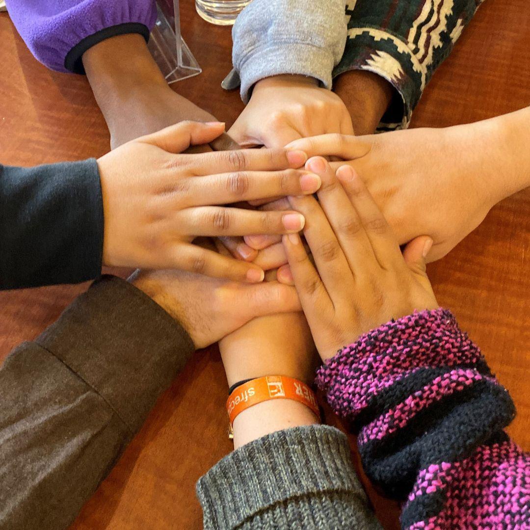 Hands Stacked from Immersion trip 