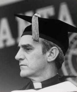 A person wearing academic regalia, including a mortarboard, at a graduation ceremony.
