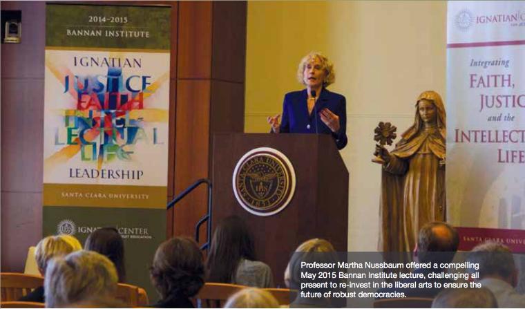 Martha Nussbaum speaking at a podium with artwork and banners in the background.