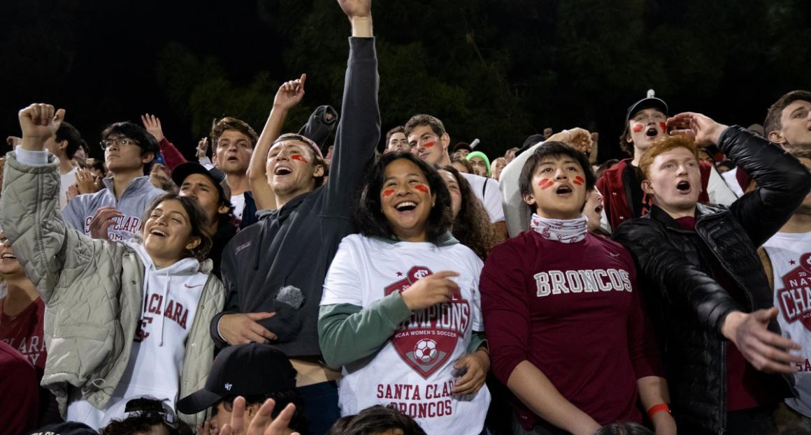 Students in SCU Women's Soccer gear cheering 