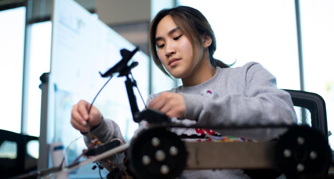 An Engineering student works on her robotic project 