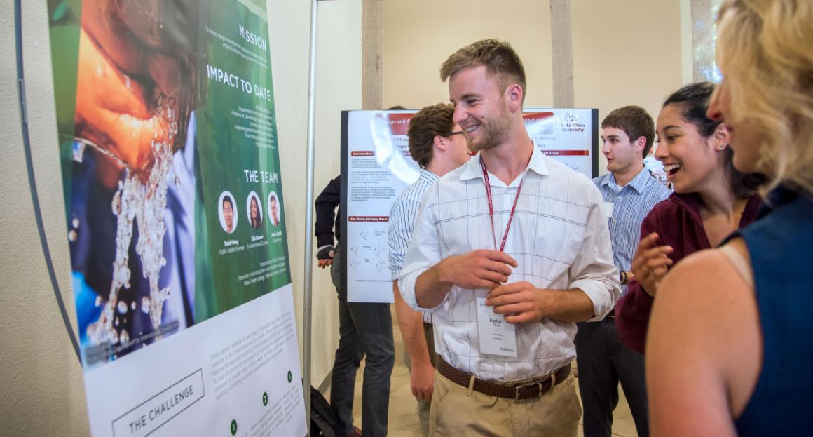 An Economics student presents his research at Open House 