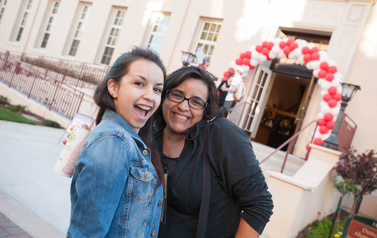 Happy faces in front of Donohoe Alumni House, location of Family Weekend check-in. Photo by Charles Barry image link to story