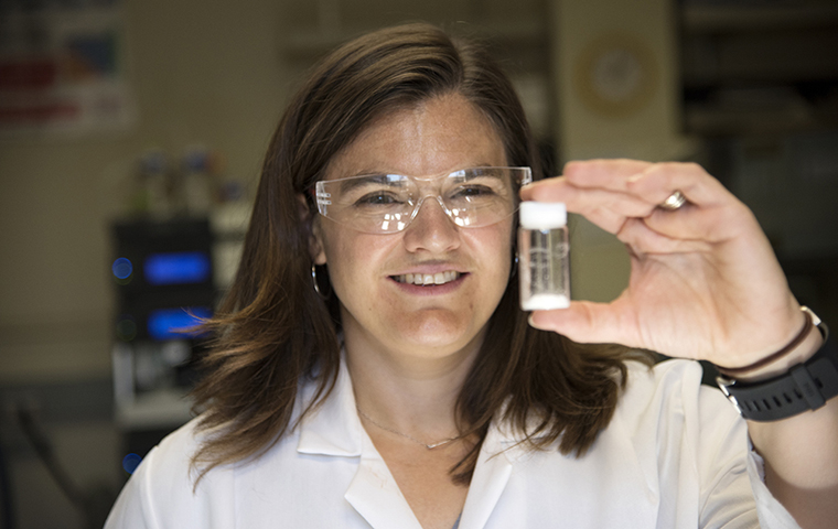 Amelia Fuller holds up a vial of sticky molecules image link to story